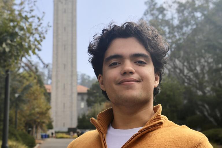 Photo of Agustin posing in front of the Berkeley Campanile