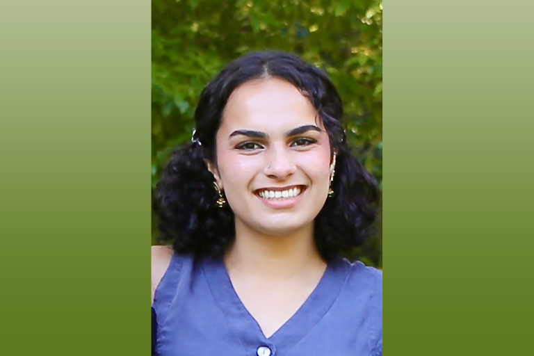 Headshot of Alishba in front of leafy tree