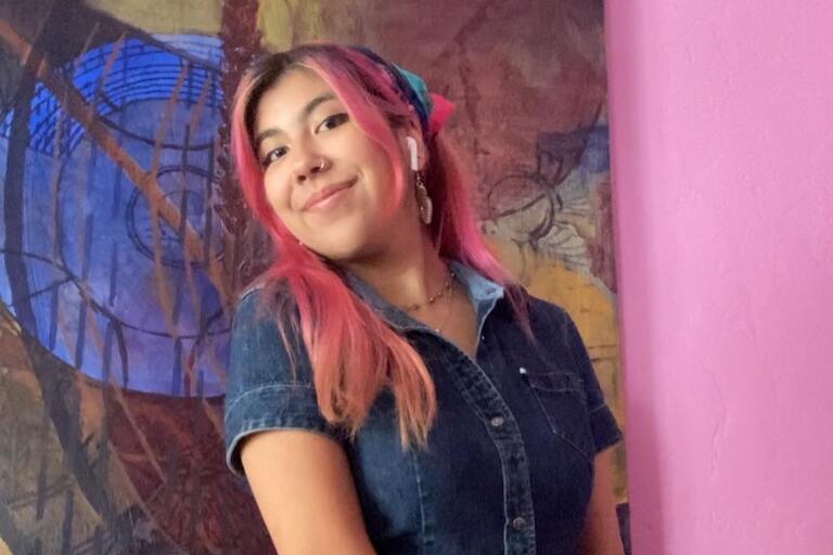 Photo of Cecelia posing in front of a painting