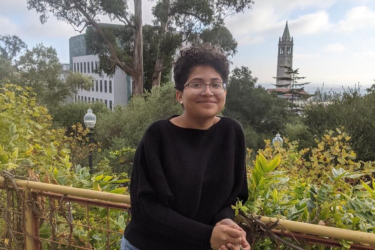 Crystal poses in front of a campus backdrop with Campanile
