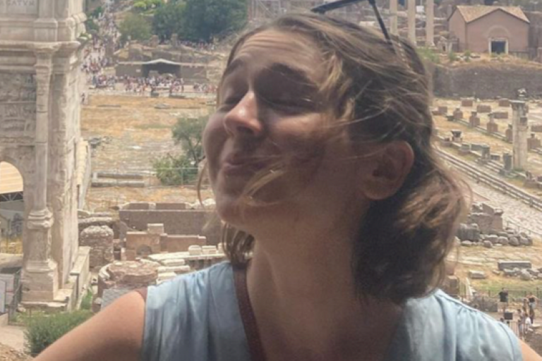 Photo of Grace in front of Roman ruins
