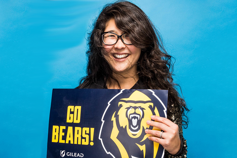 Rebecca Ricksen holding "go bears" sign