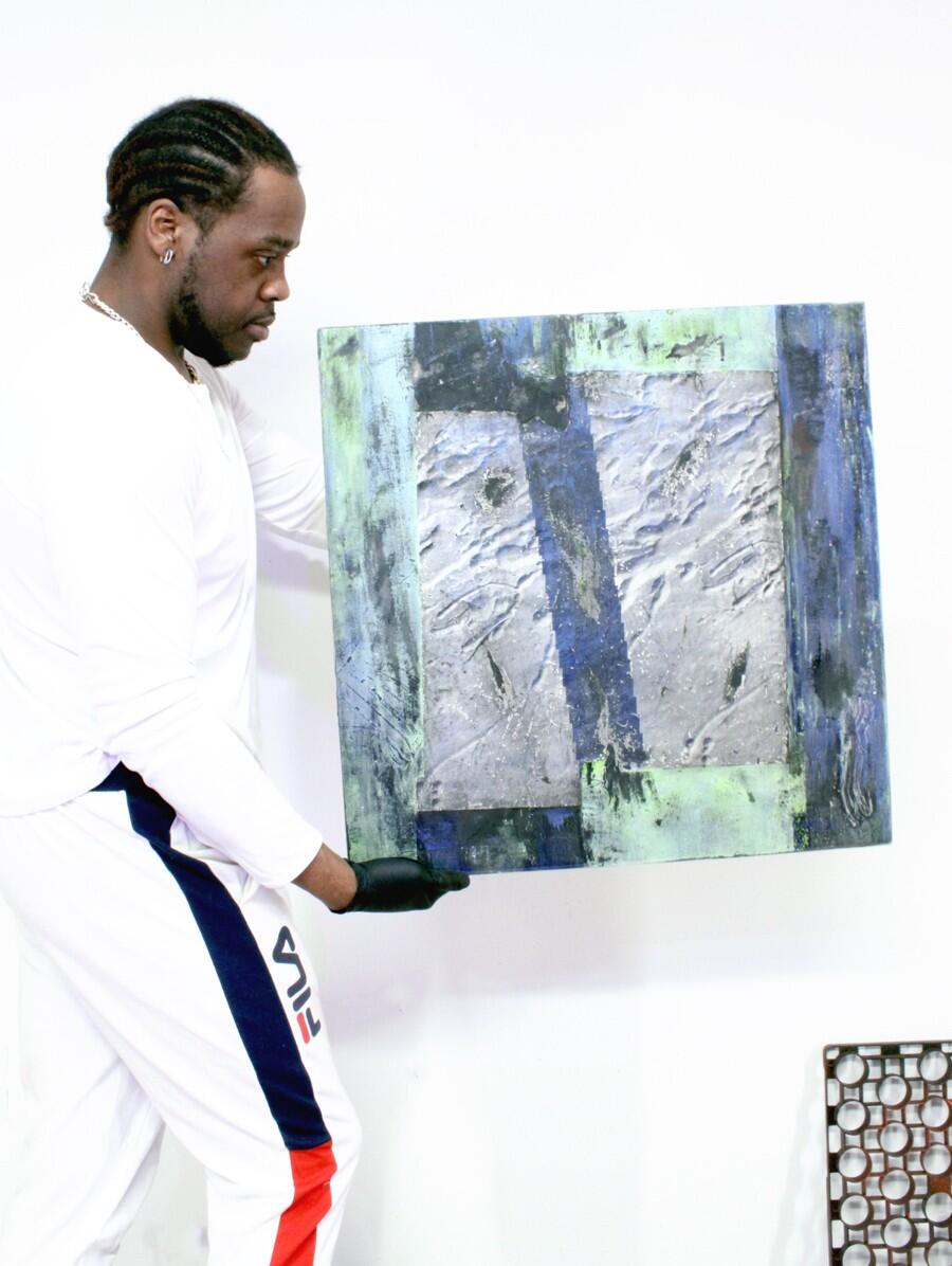 artist holding a painting