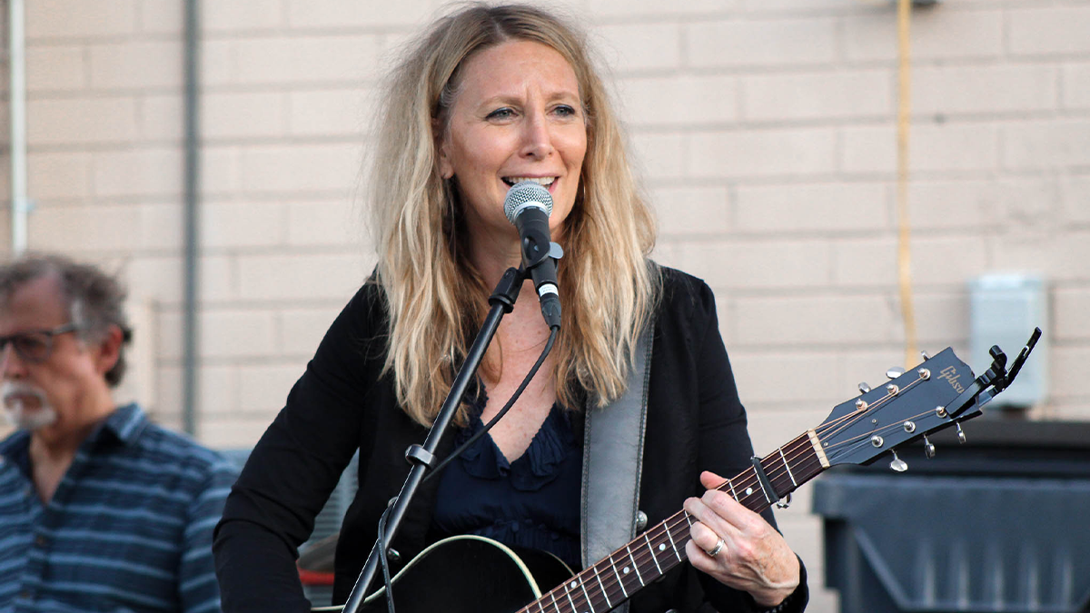 woman plays guitar onstage