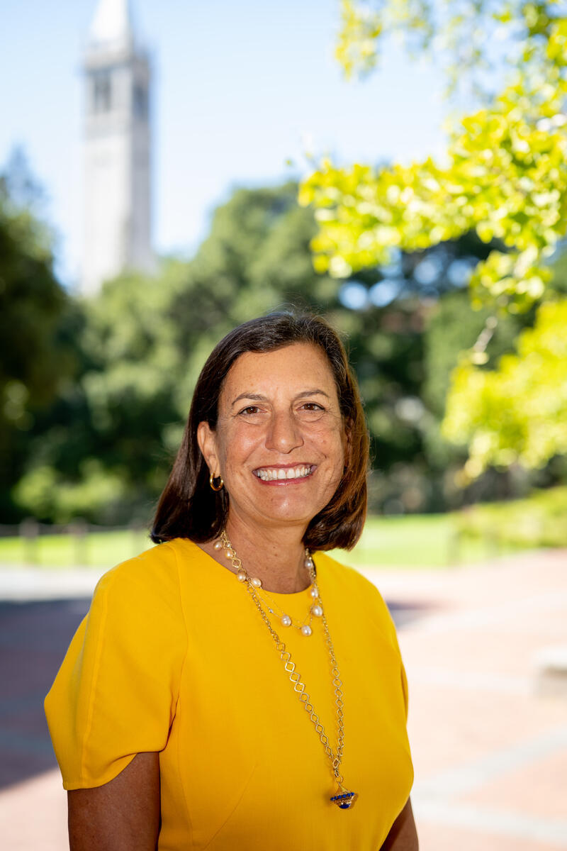 woman in yellow dress with campanile in background