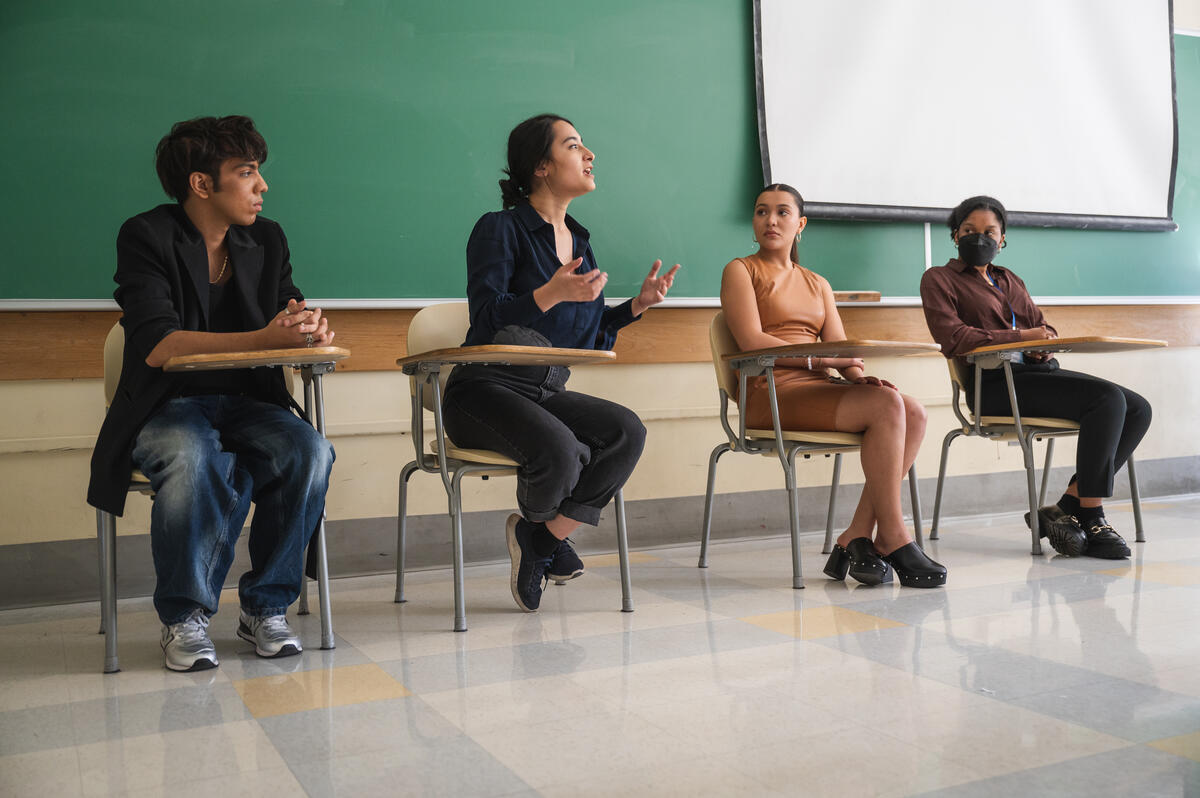 four students sitting in the classroom