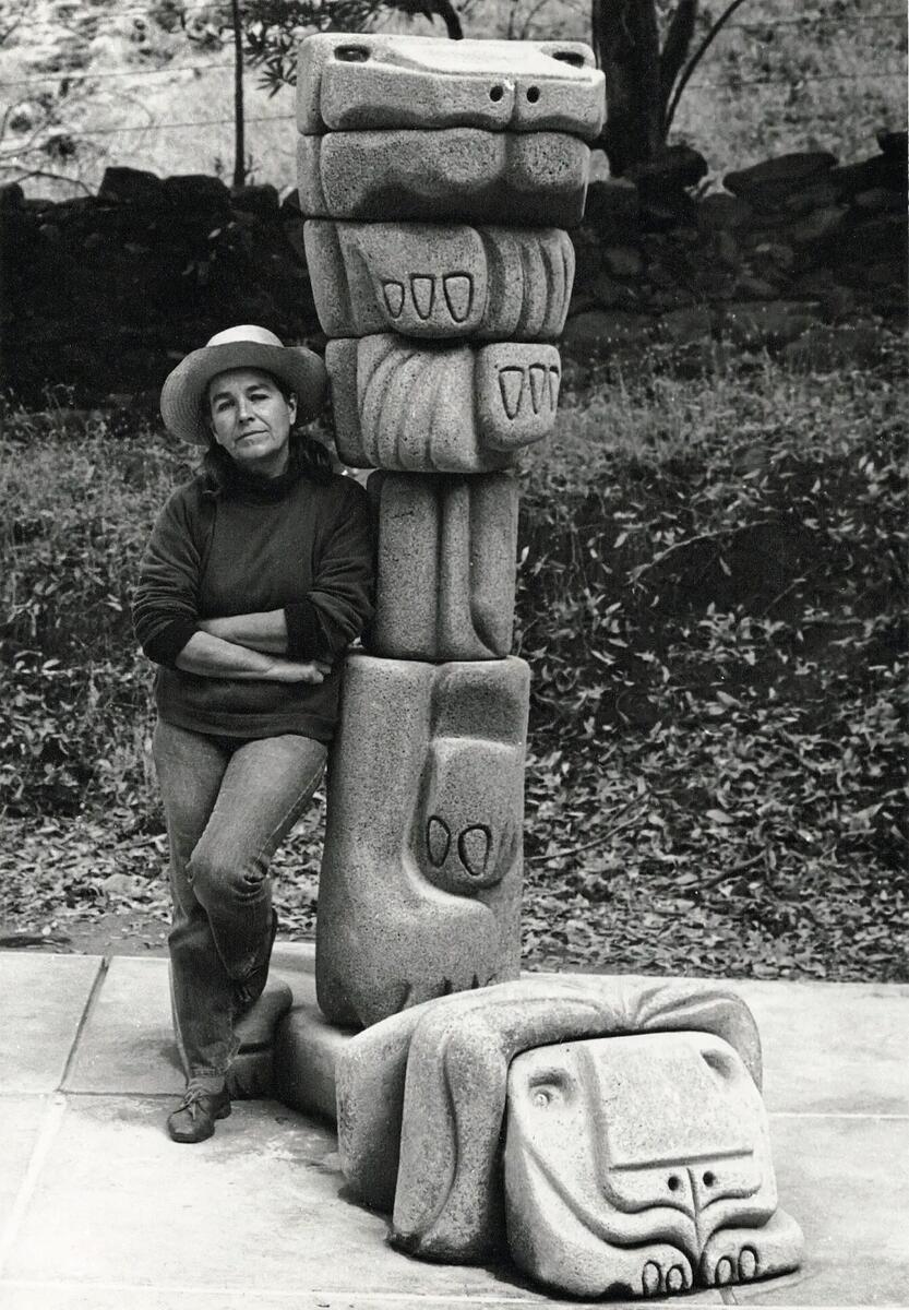 woman leaning on a sculpture
