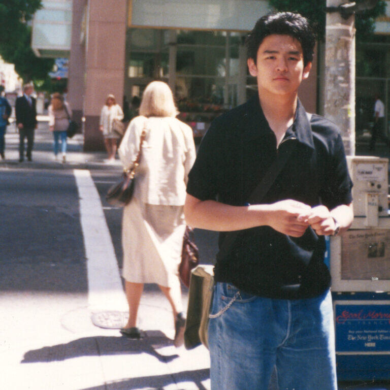 Young john cho standing on a corner