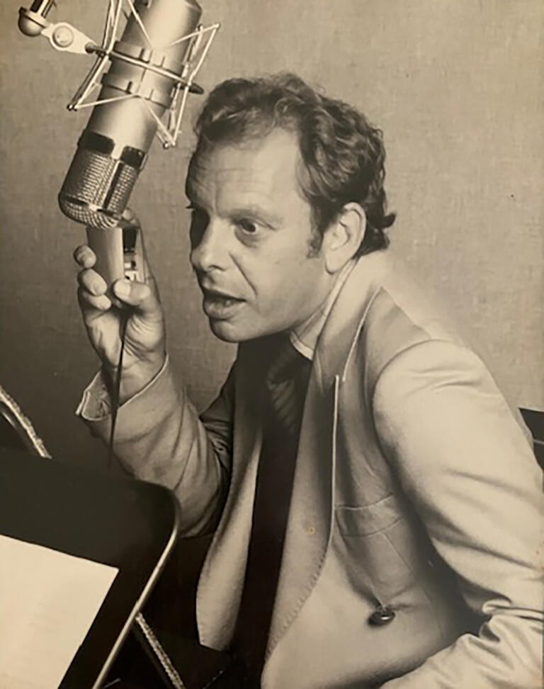 sepia photograph of man speaking energetically into microphone