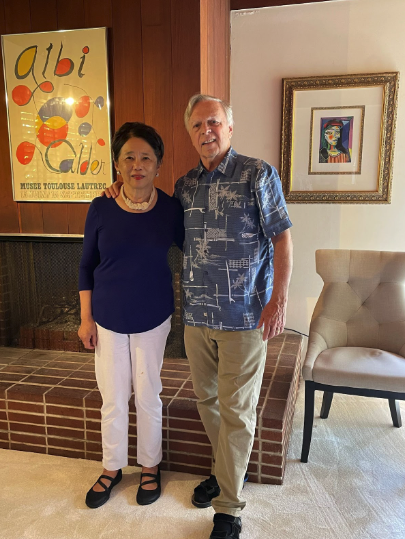 Couple stands in front of fireplace