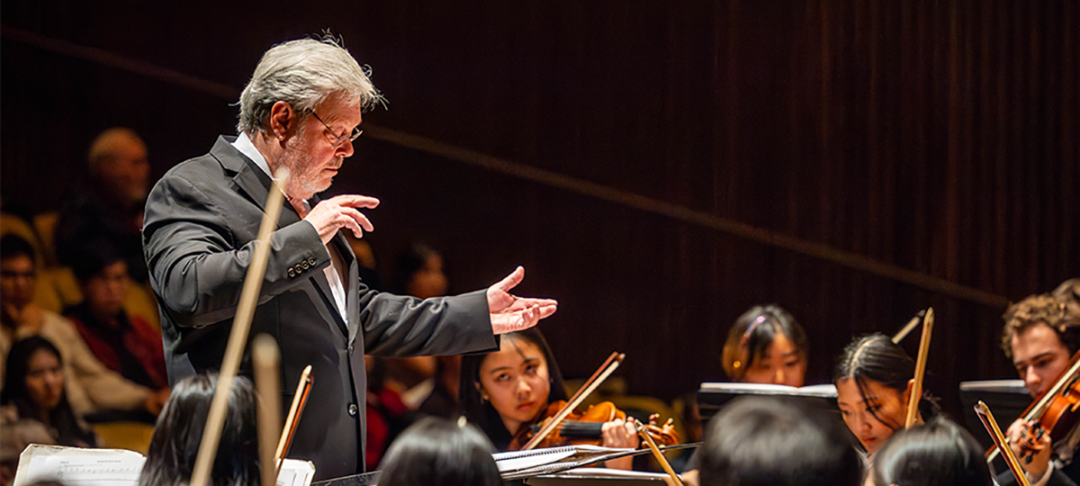 professor David Milnes conducts student orchestra