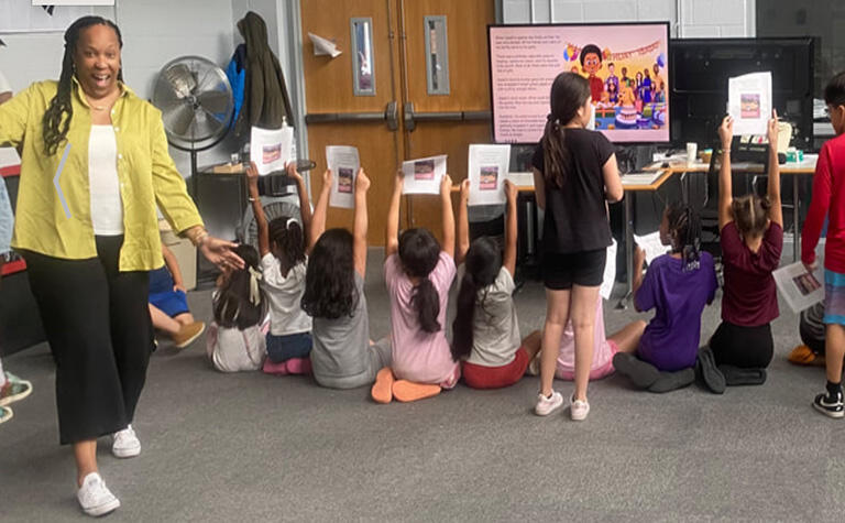 woman with joyful expression in room full of children