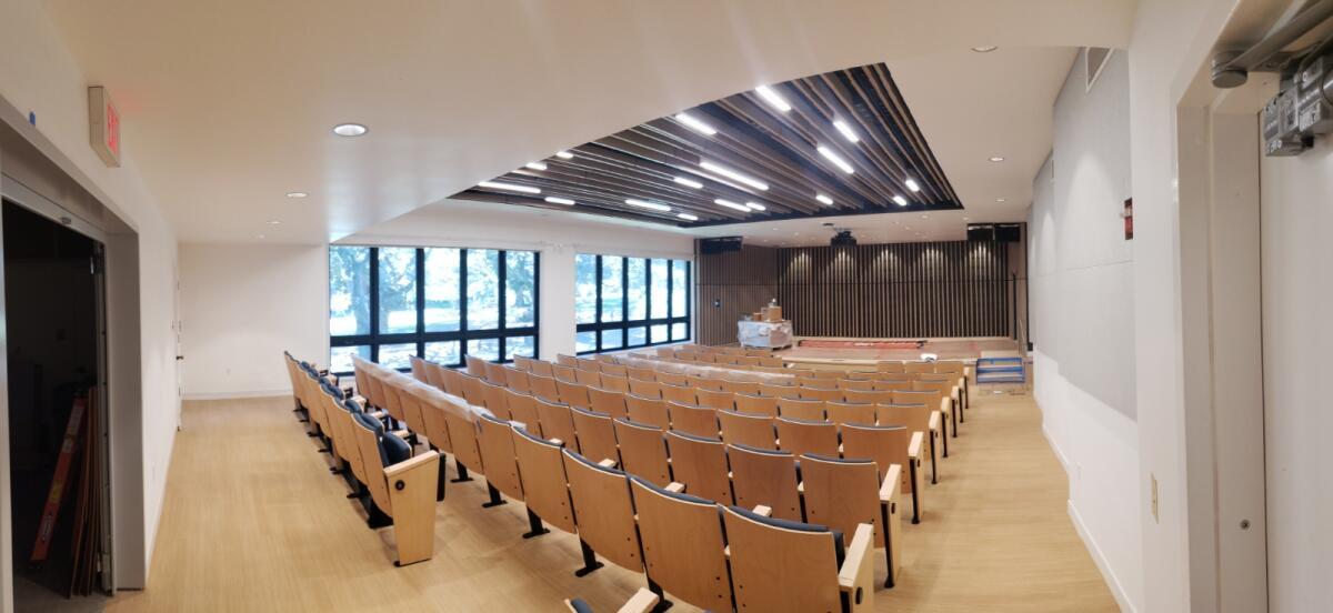 a performance space with rows of seats and a stage