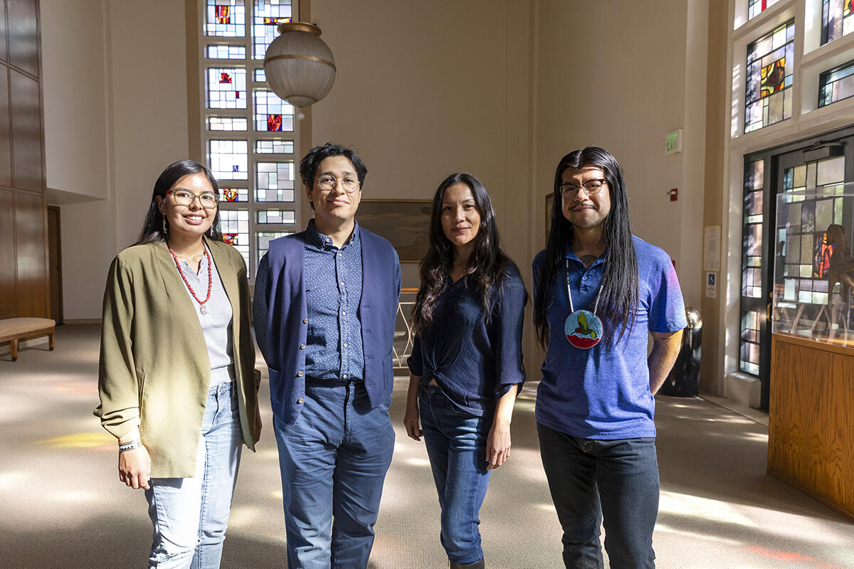 four people stand next to eachother