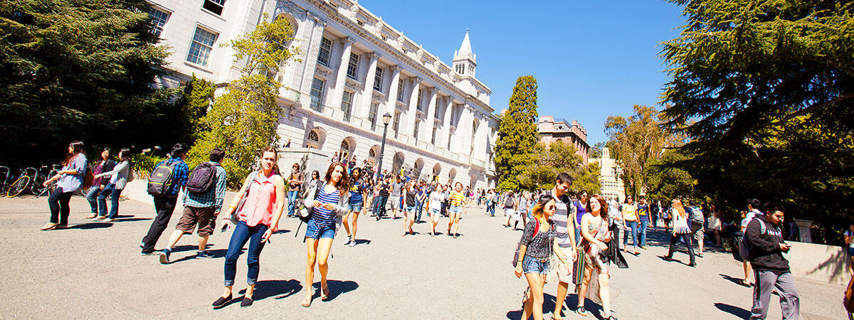 Students walking with Wheeler Hall in background