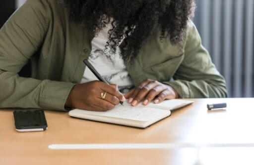 Photo of a student writing in their journal