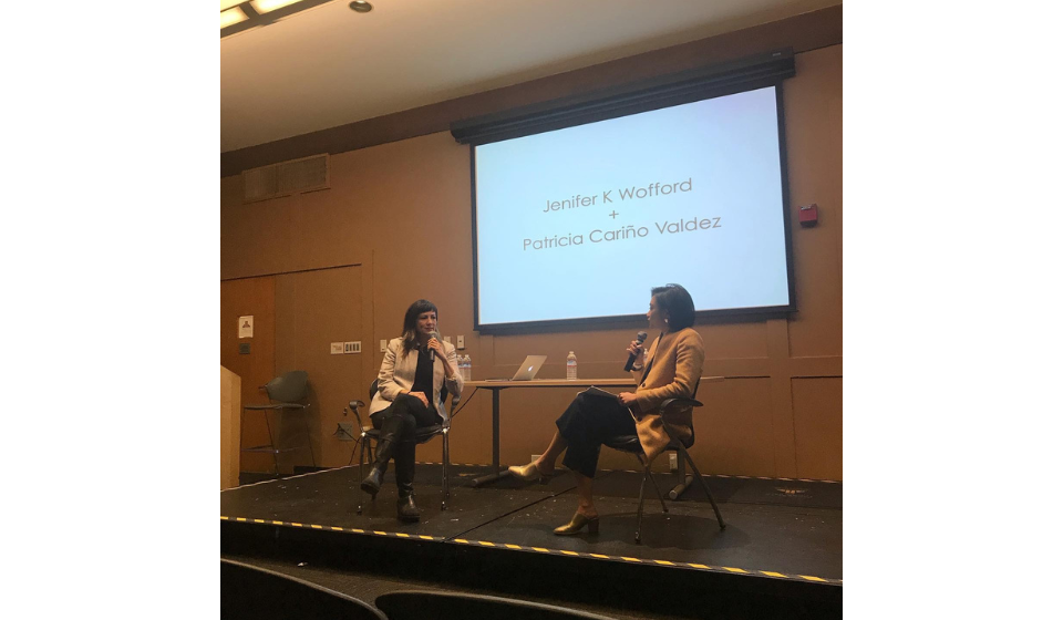 two people in conversation on a stage